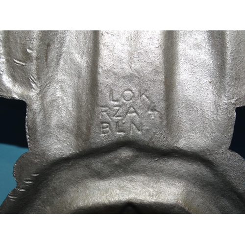 554 - A WWII Third Reich cast alloy eagle and swastika insignia, incised on reverse HE (monogram) G AL Mg ... 