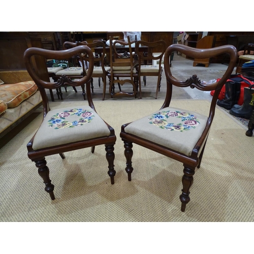 7 - A set of eight Victorian balloon-back dining chairs with drop-in seats, on turned and carved legs.... 