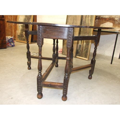 9 - An antique oak drop-leaf dining table, 121 x 138cm open, on carved and later turned feet.... 