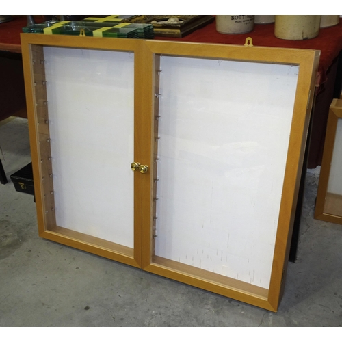 16 - A modern tower display cabinet of tapered form, with three glazed sides and glass shelves, 174cm hig... 