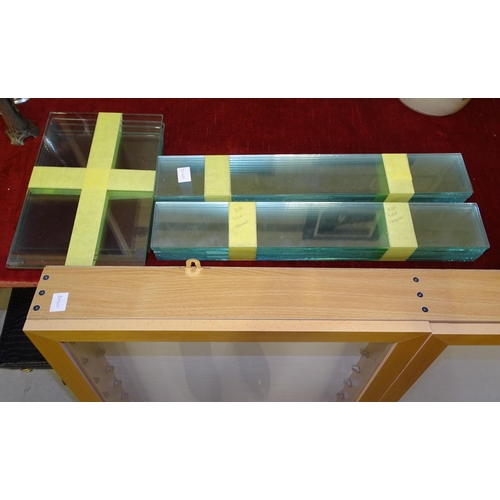 16 - A modern tower display cabinet of tapered form, with three glazed sides and glass shelves, 174cm hig... 