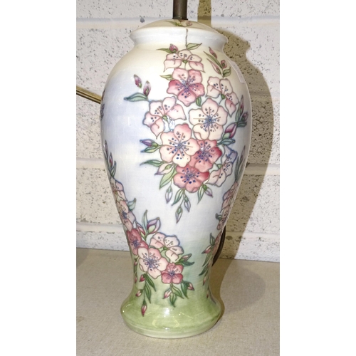 25 - A Moorcroft pottery table lamp decorated in the apple blossom pattern, 44cm high overall.... 