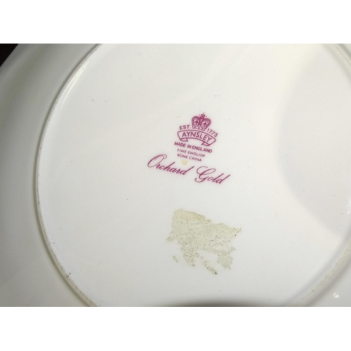 30 - An Aynsley 'Orchard Gold' tea part-set, comprising: two-handled sugar bowl with lid, 9.5cm high, mil... 