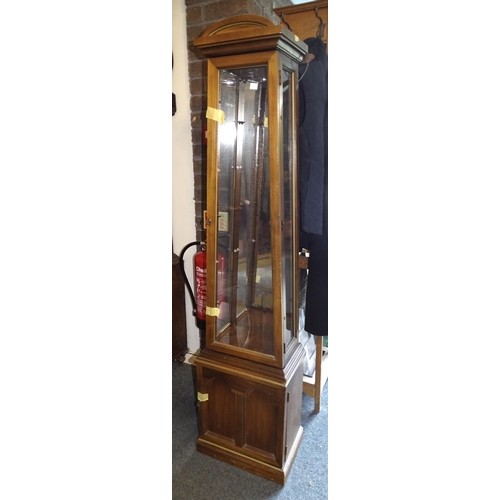 16 - A modern tower display cabinet of tapered form, with three glazed sides and glass shelves, 174cm hig... 