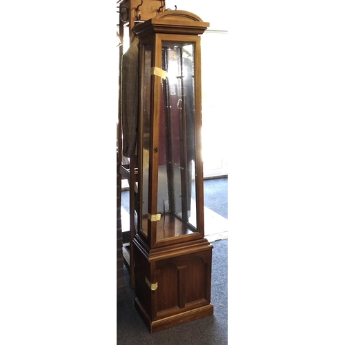 16 - A modern tower display cabinet of tapered form, with three glazed sides and glass shelves, 174cm hig... 
