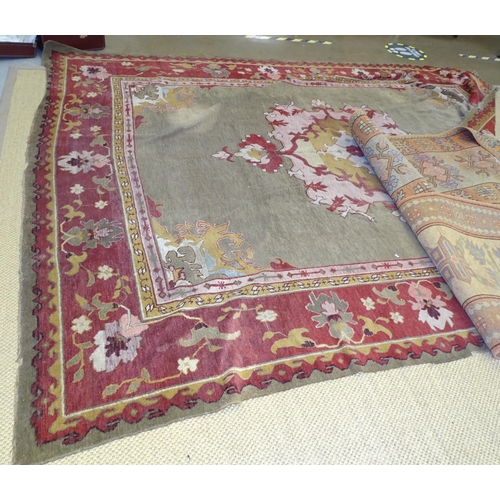 17 - A 20th century wool carpet, 277 x 360cm, (worn and damaged) and two pale-coloured wool corridor rugs... 
