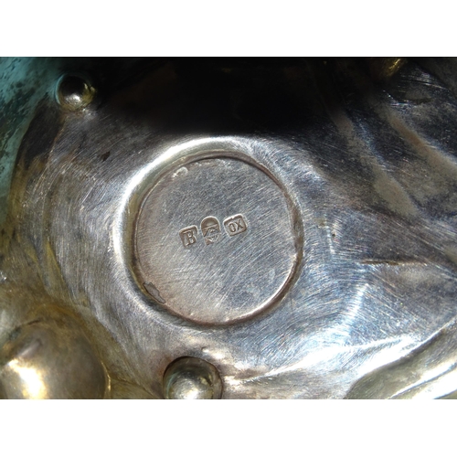 62 - A WMF silver-plated salt stand decorated with a cherub sitting beside a pond with two water lilies c... 