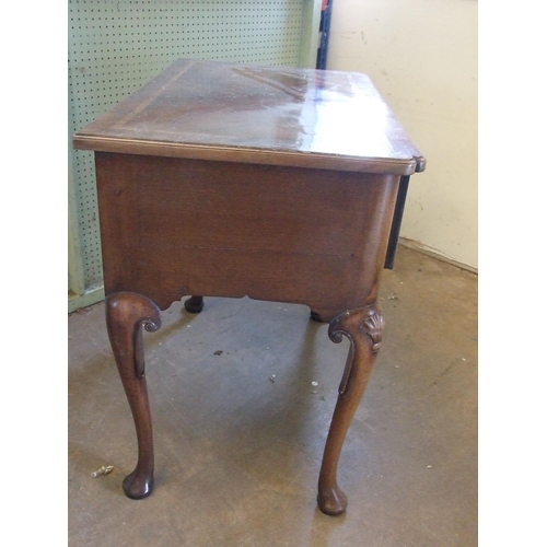 49 - An antique walnut lowboy, the crossbanded top above three drawers, on shell-carved cabriole legs, 79... 