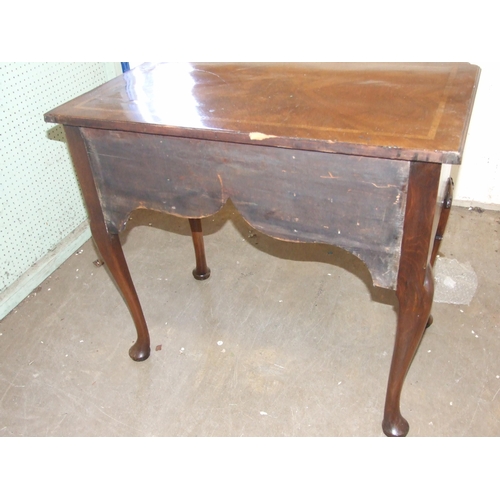 49 - An antique walnut lowboy, the crossbanded top above three drawers, on shell-carved cabriole legs, 79... 