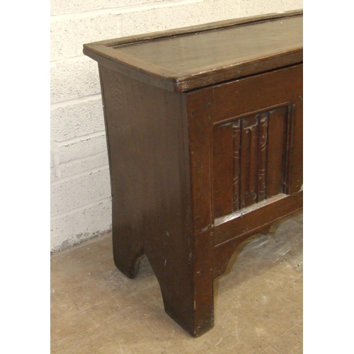 52 - An antique oak six-plank coffer, unusually the lid applied with moulded edge, the front panel carved... 