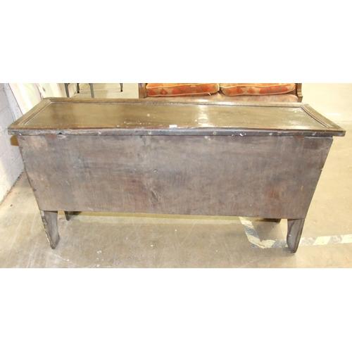 52 - An antique oak six-plank coffer, unusually the lid applied with moulded edge, the front panel carved... 