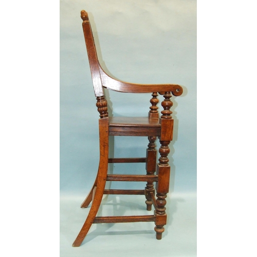 53 - An antique highchair for a child, with arched panel back and solid seat, on turned legs, 105cm high,... 