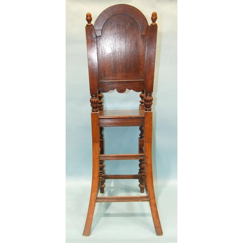 53 - An antique highchair for a child, with arched panel back and solid seat, on turned legs, 105cm high,... 