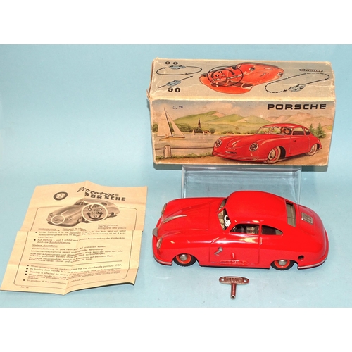 A JNF Prototyp Porsche Automatic tinplate clockwork model car in red, made in Western Germany, with box numbered 56, JNF key and instructions, (near mint, one small scratch under door handle, box-flaps missing at one end).
