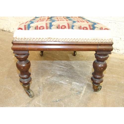 24 - A Victorian rosewood child's prayer chair, with typically high back and raised on brass castors, (wo... 