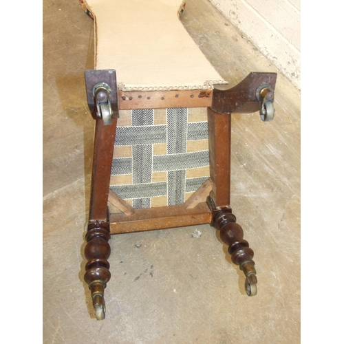24 - A Victorian rosewood child's prayer chair, with typically high back and raised on brass castors, (wo... 