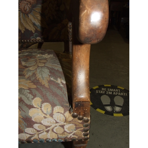 39 - A pair of antique Continental walnut-framed high-back armchairs with downswept arms and shaped legs ... 
