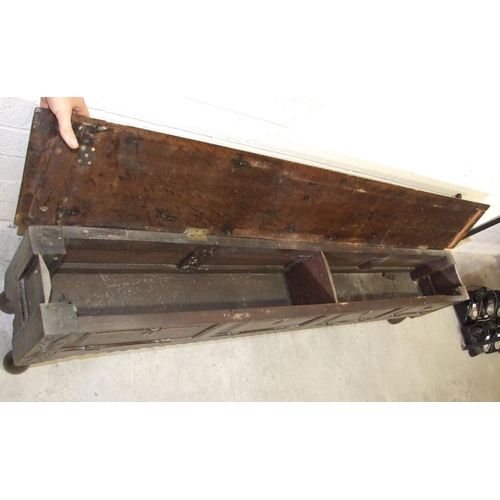 53 - An unusual antique oak low hall settle of panelled construction, the rectangular later hinged top ha... 