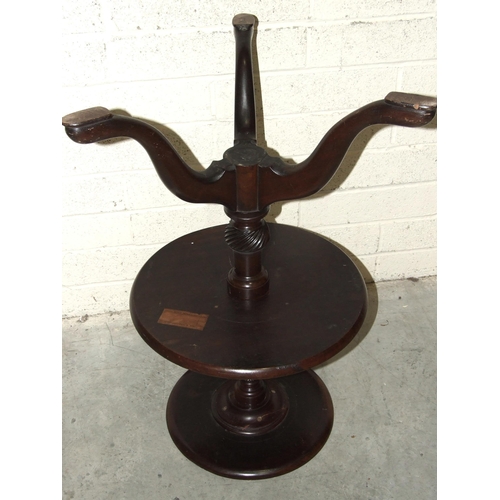 54 - An 18th century mahogany two-tier circular dumb waiter, having a fluted and spiral reeded turned col... 