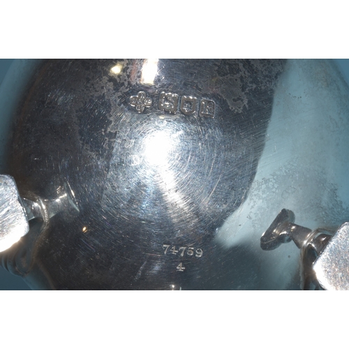 12 - An Edwardian silver mustard of circular form, with gadrooned rim and hinged lid, on three hoof feet,... 