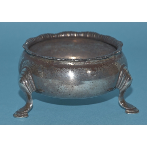 12 - An Edwardian silver mustard of circular form, with gadrooned rim and hinged lid, on three hoof feet,... 