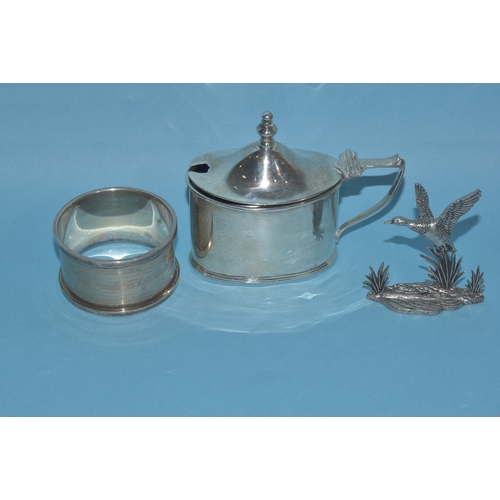 17 - A George V silver oval-shaped mustard, 8cm long, 6.5cm high, with spoon and blue glass liner, Birmin... 