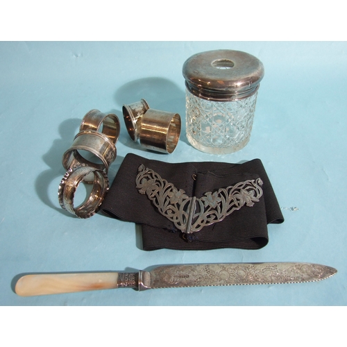 31 - A collection of five silver napkin rings, various dates, ___4oz, 124.6g, a silver-top cut-glass hair... 