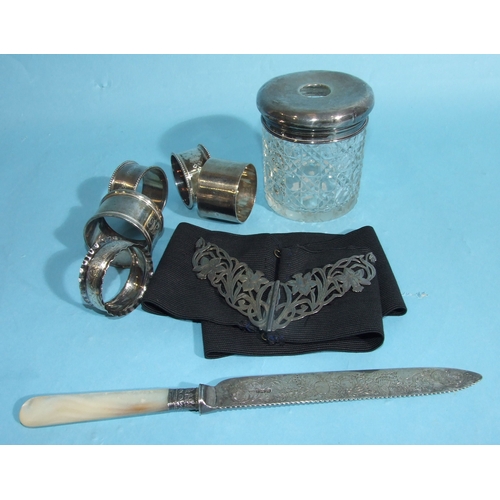 31 - A collection of five silver napkin rings, various dates, ___4oz, 124.6g, a silver-top cut-glass hair... 