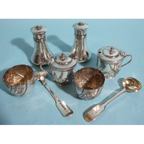 35 - A pair of small silver mustard pots with embossed decoration, 6cm high, Birmingham 1894, one with ce... 