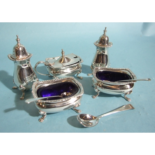 43 - A Mappin & Webb silver cruet set, comprising: mustard pot with blue glass liner, two open salts,... 