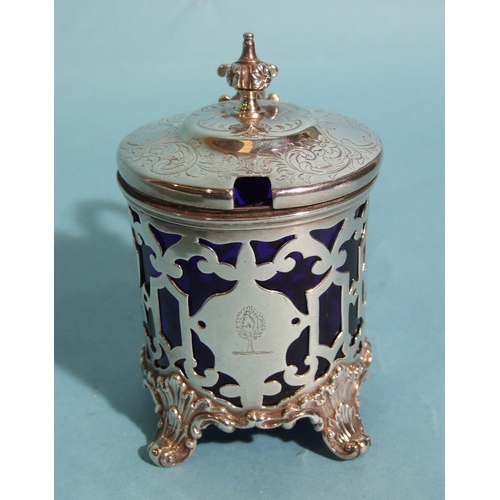 57 - A Victorian silver mustard of circular form, with pierced decorated body and engraved hinged lid, fi... 