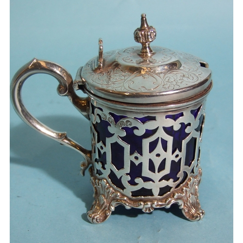 57 - A Victorian silver mustard of circular form, with pierced decorated body and engraved hinged lid, fi... 
