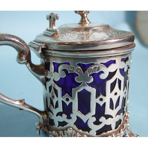 57 - A Victorian silver mustard of circular form, with pierced decorated body and engraved hinged lid, fi... 