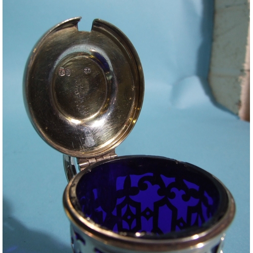 57 - A Victorian silver mustard of circular form, with pierced decorated body and engraved hinged lid, fi... 
