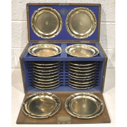 A set of twenty-four silver-gilt dinner plates, each with reeded and beaded border and engraved armorial to the centre, 23.5cm diameter, London 1808, maker's mark WE, in fitted box, sold by Thomas of New Bond Street, engraved armorial with motto Noli Me Tangere (touch me not) around a pelican with wings raised, total weight 12,154.1g, ___393.7oz.