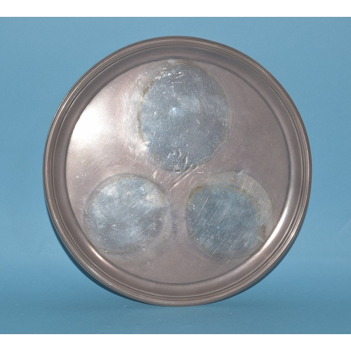 9 - A George III circular silver card tray raised on three feet, engraved with central crest (faded), Lo... 