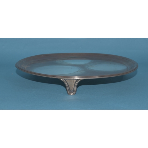 9 - A George III circular silver card tray raised on three feet, engraved with central crest (faded), Lo... 