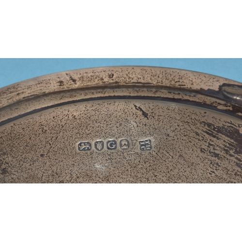 9 - A George III circular silver card tray raised on three feet, engraved with central crest (faded), Lo... 