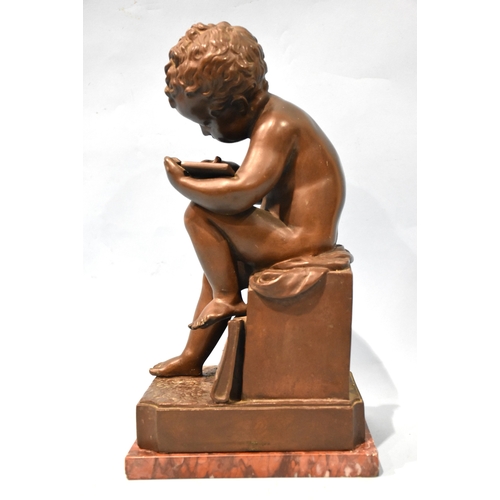 23 - A 19th century bronze Le Petit Ecrivain, depicting a child writing on a tablet and seated on a plint... 