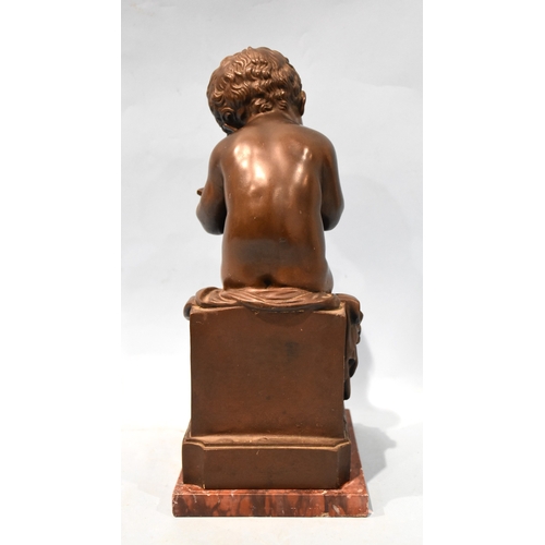 23 - A 19th century bronze Le Petit Ecrivain, depicting a child writing on a tablet and seated on a plint... 