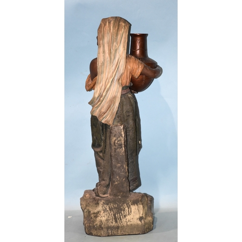 29 - A large late-19th century German earthenware model of a Turkish/Arab water carrier, in gilt and colo... 