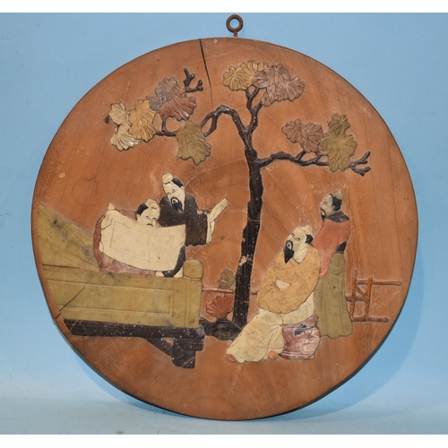 36 - A 19th century Chinese circular wooden plaque inlaid with coloured stones depicting scholars on a te... 