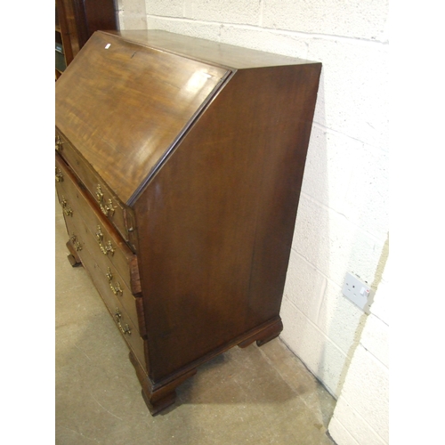 5 - A George III mahogany bureau, the fall front enclosing the serpentine-shaped inlaid satinwood fitmen... 