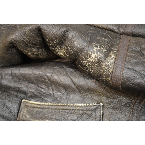 55 - A brown leather and sheepskin flying jacket, no manufacturer's label, size 12, (worn) and another wi... 