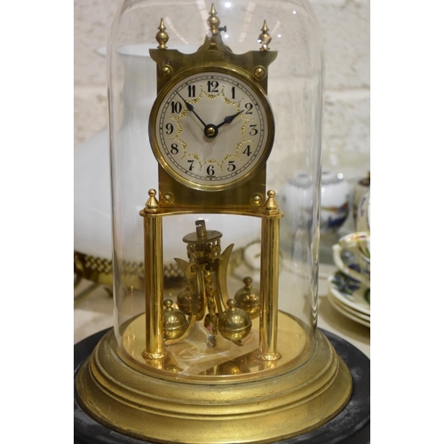 27 - A German-made 400-day brass clock under glass dome, with circular wooden base, 33cm high overall, a/... 