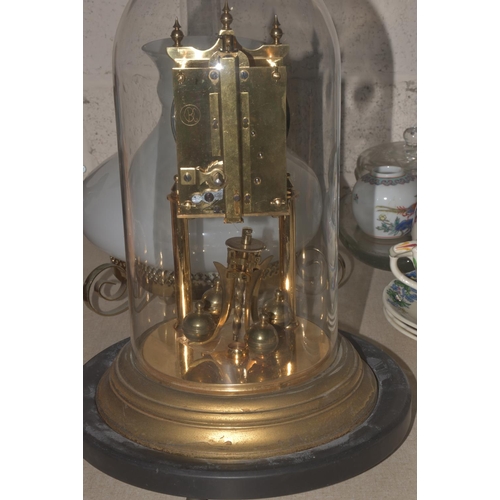 27 - A German-made 400-day brass clock under glass dome, with circular wooden base, 33cm high overall, a/... 