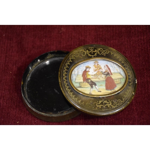 59 - A small circular tortoiseshell-lined box and cover, the cover with an oval painted scene of a couple... 