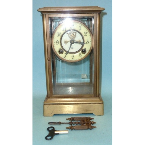23 - A late-19th century four-glass brass mantel clock, the two-piece dial with visible escapement and go... 