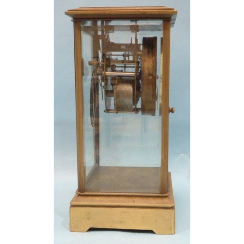 23 - A late-19th century four-glass brass mantel clock, the two-piece dial with visible escapement and go... 