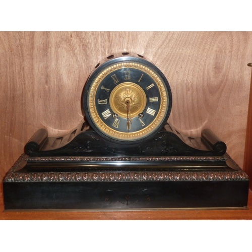 24 - A large metal-mounted black marble mantel clock, the dial with metal Roman numerals and gong-strikin... 